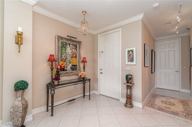 tiled entryway featuring rail lighting and crown molding