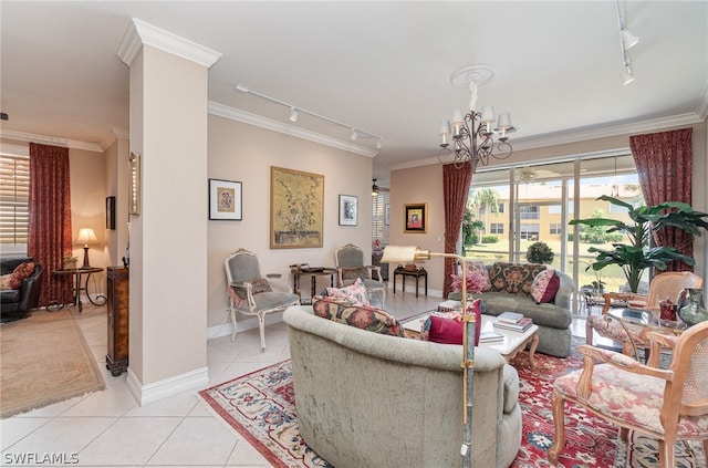 living room with a chandelier, light tile floors, track lighting, and ornamental molding