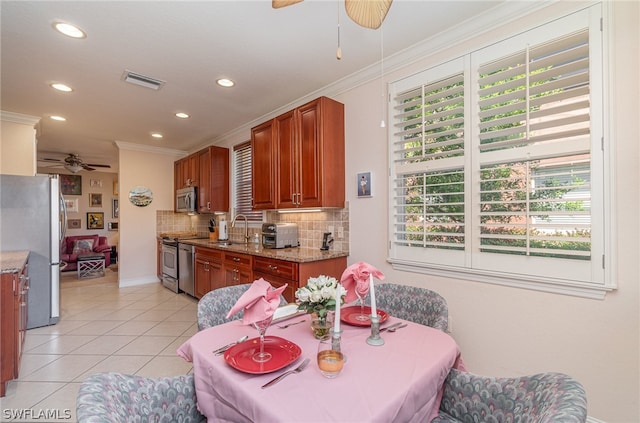 dining area with plenty of natural light, ceiling fan, sink, and light tile flooring