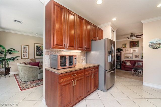 kitchen featuring tasteful backsplash, ceiling fan, light tile floors, and light stone counters