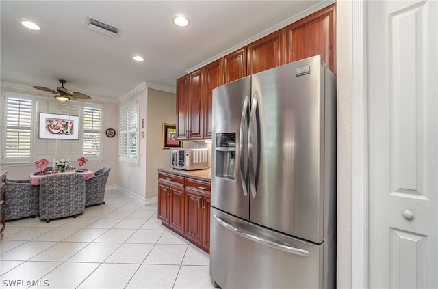 kitchen with light stone countertops, stainless steel fridge with ice dispenser, ceiling fan, crown molding, and light tile floors