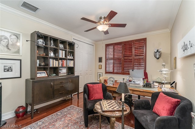 home office with crown molding, dark wood-type flooring, and ceiling fan