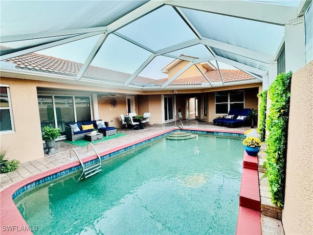 view of pool with a patio, an outdoor living space, and glass enclosure