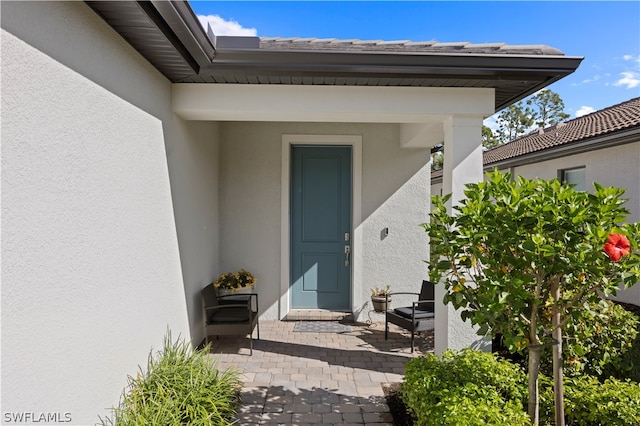 entrance to property with a patio