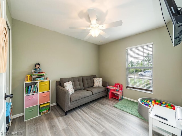 rec room featuring ceiling fan and light wood-type flooring