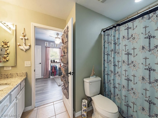 bathroom featuring ceiling fan, hardwood / wood-style floors, vanity, and toilet