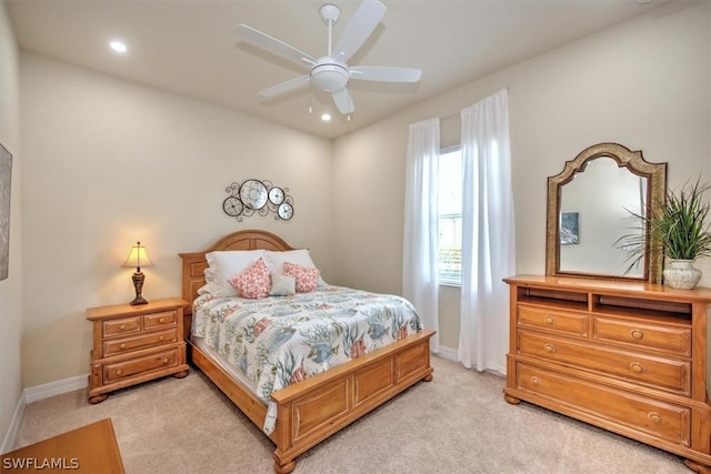 bedroom featuring light colored carpet and ceiling fan