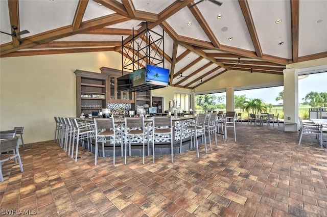 interior space featuring beam ceiling and high vaulted ceiling