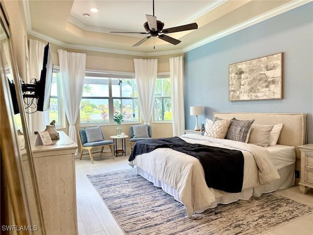 bedroom with a raised ceiling, crown molding, ceiling fan, and light hardwood / wood-style floors