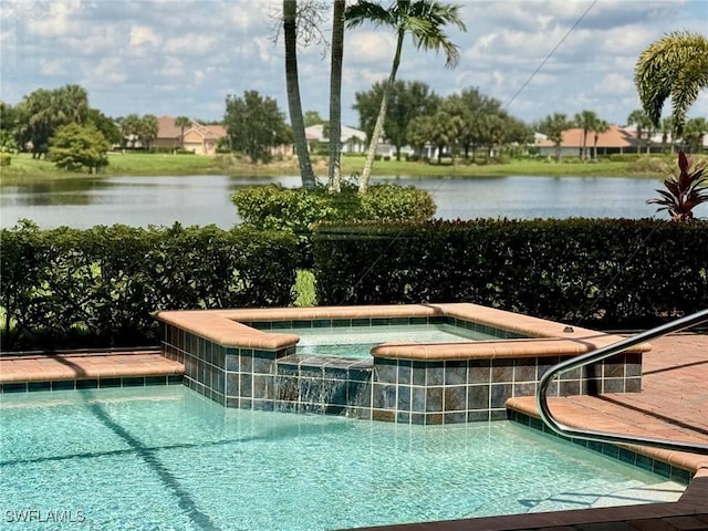 view of pool featuring an in ground hot tub and a water view