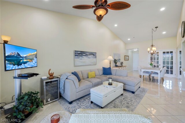 living room featuring ceiling fan with notable chandelier, wine cooler, and high vaulted ceiling