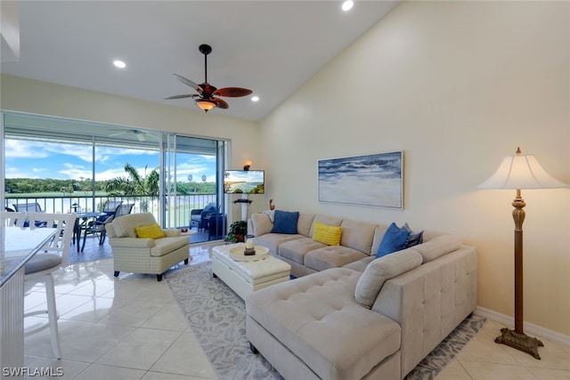 living room with ceiling fan, high vaulted ceiling, and light tile patterned floors