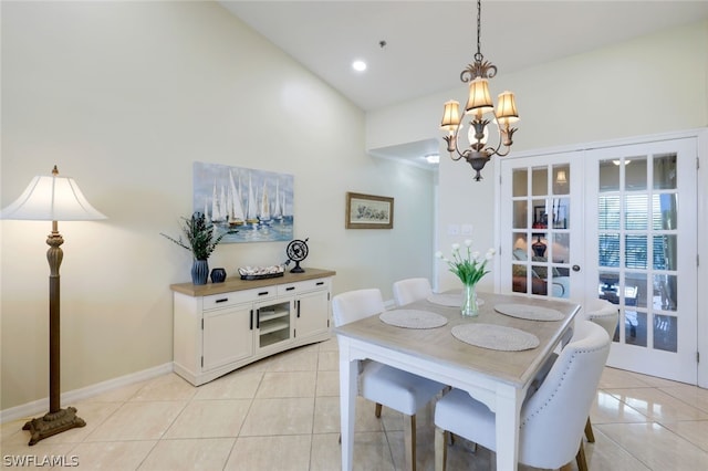 dining area featuring light tile patterned flooring, vaulted ceiling, a chandelier, and french doors