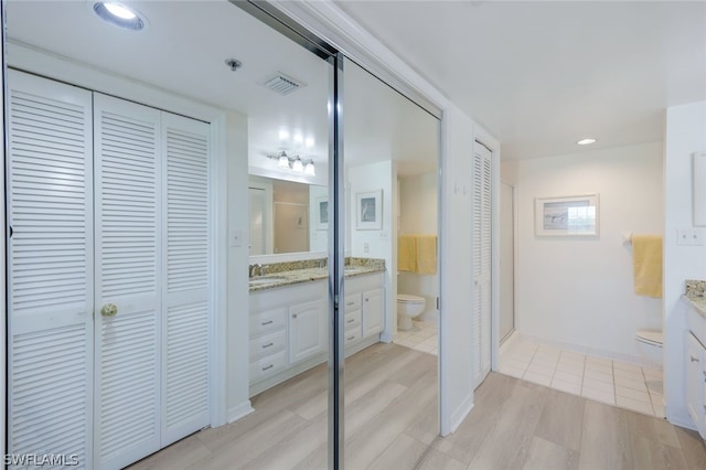 bathroom featuring hardwood / wood-style flooring, vanity, and toilet