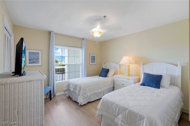 bedroom with ceiling fan, a closet, and light hardwood / wood-style flooring