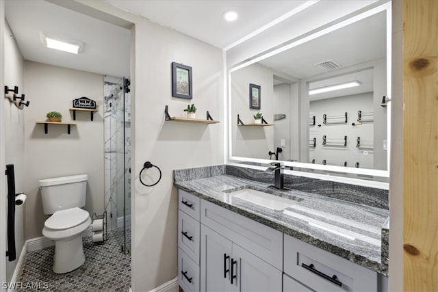 bathroom with tile floors, vanity, and toilet