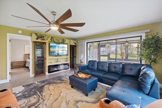 living room featuring hardwood / wood-style floors and ceiling fan