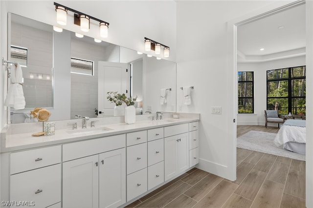 bathroom featuring vanity, hardwood / wood-style flooring, and walk in shower