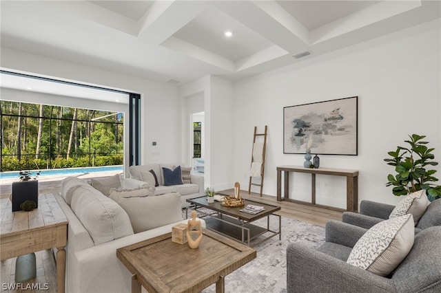 living room with beam ceiling, coffered ceiling, and hardwood / wood-style flooring