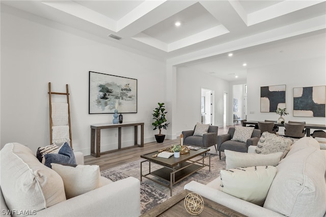 living room with beamed ceiling and light wood-type flooring