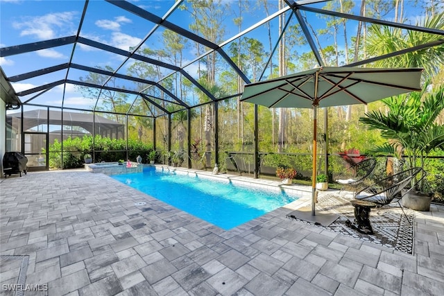 view of pool with a lanai, a patio area, and area for grilling