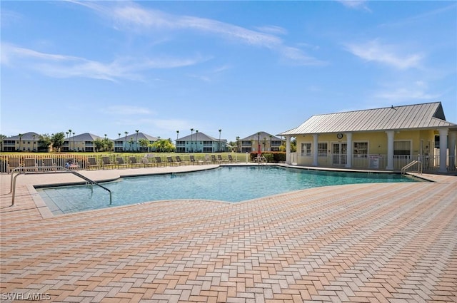 pool featuring a residential view, fence, and a patio