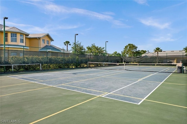 view of tennis court with fence