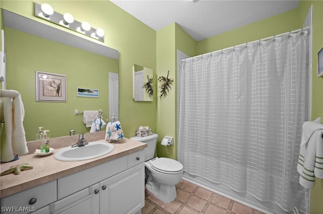 bathroom featuring shower / tub combo, vanity, and toilet