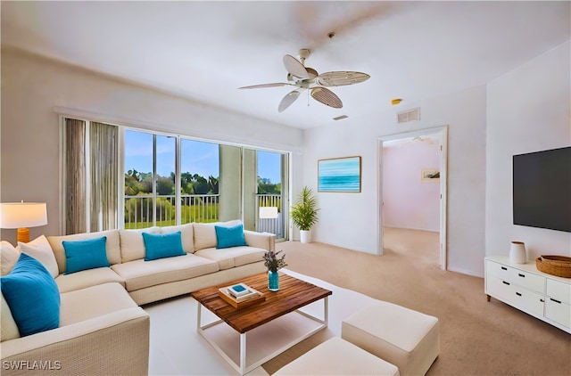 living room featuring ceiling fan and light colored carpet