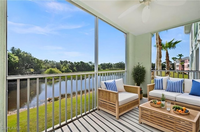 sunroom / solarium featuring a water view and a ceiling fan