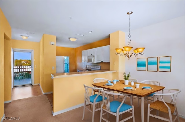 carpeted dining space featuring a notable chandelier