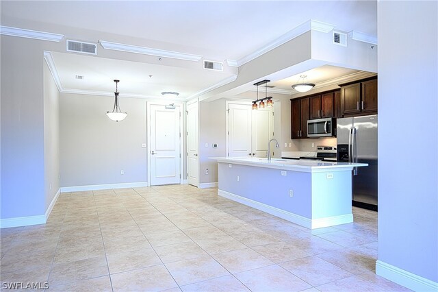 kitchen with dark brown cabinetry, appliances with stainless steel finishes, light tile floors, decorative light fixtures, and a center island with sink