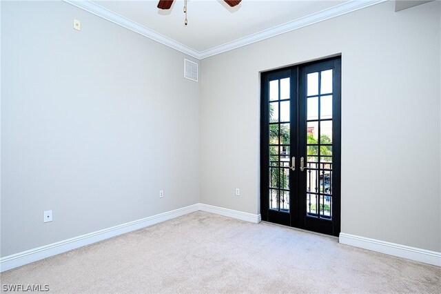 carpeted empty room with ornamental molding, french doors, and ceiling fan