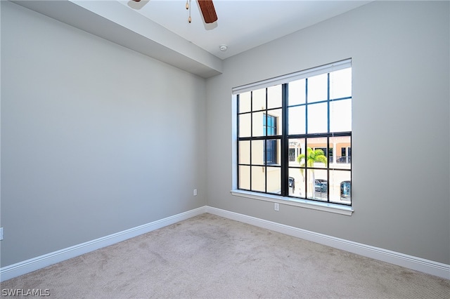 carpeted spare room featuring ceiling fan