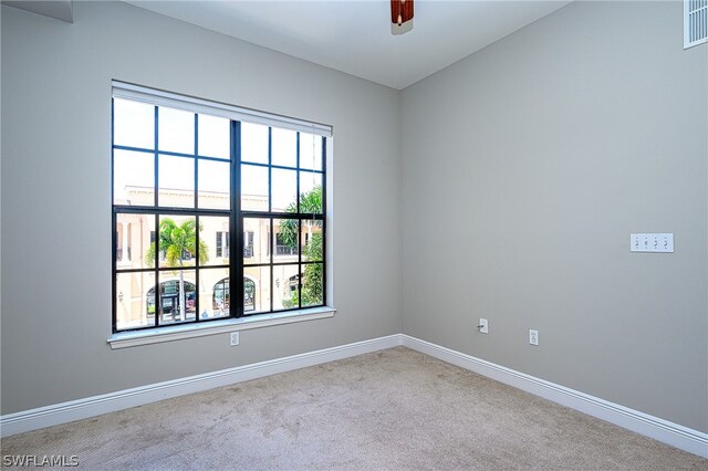 empty room with light carpet and ceiling fan