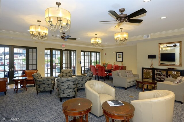 carpeted living room with ornamental molding, french doors, and ceiling fan with notable chandelier