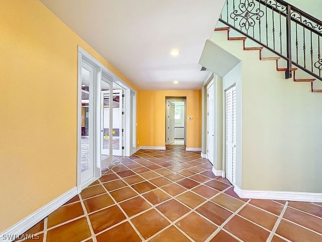 entryway with dark tile flooring