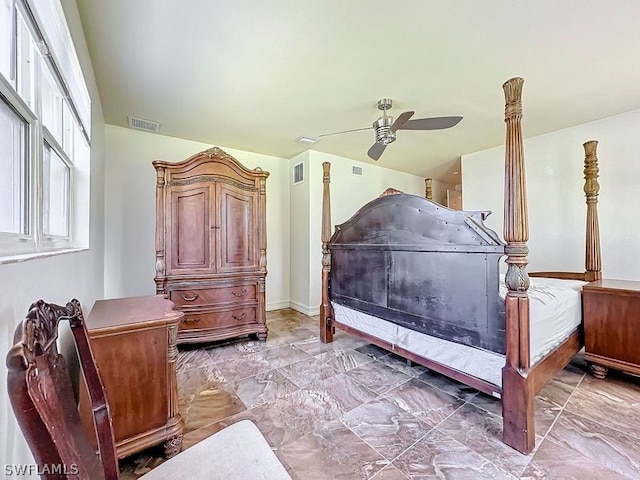 bedroom with ceiling fan and tile floors