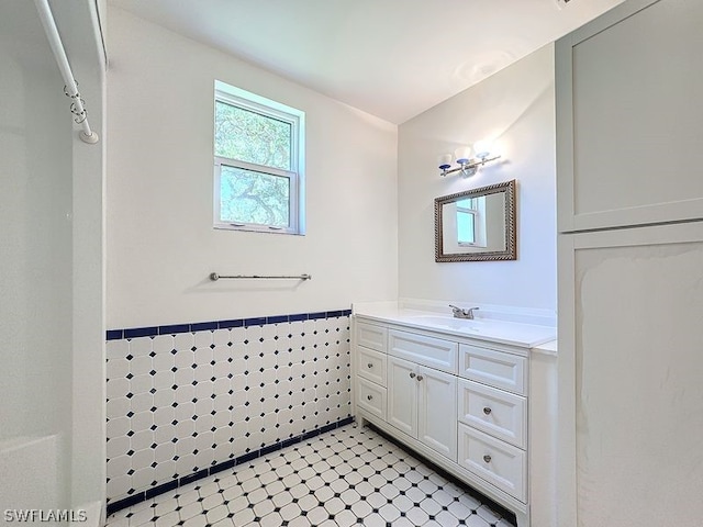 bathroom with tile walls, oversized vanity, and tile floors