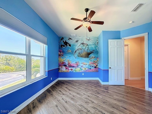 spare room with light hardwood / wood-style flooring and ceiling fan