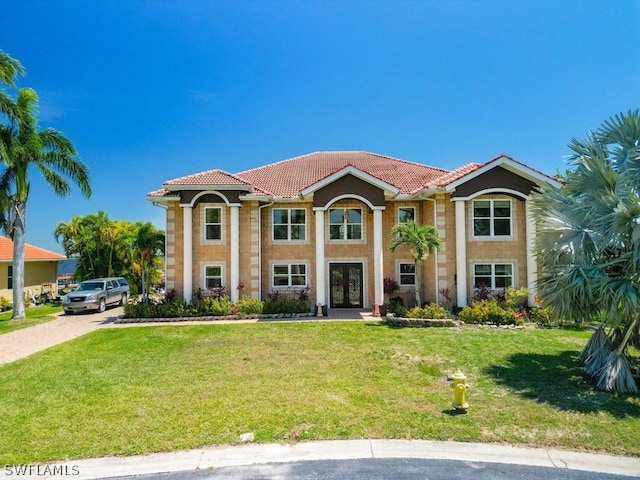 mediterranean / spanish-style home featuring a front yard