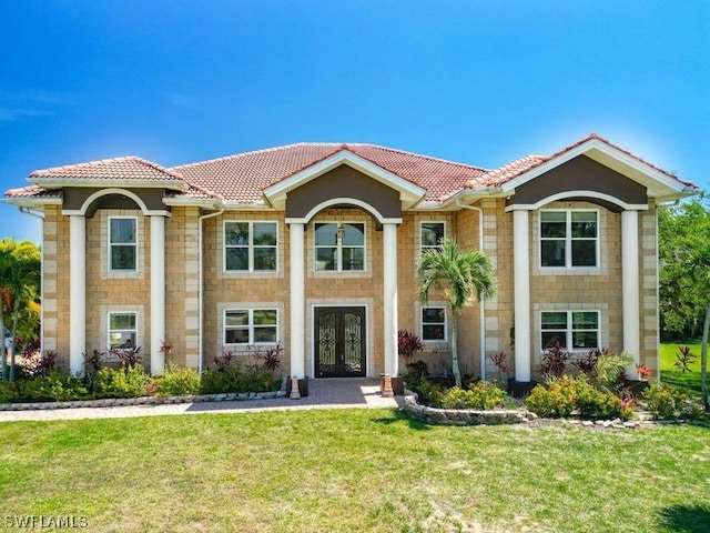 mediterranean / spanish-style house with a front yard