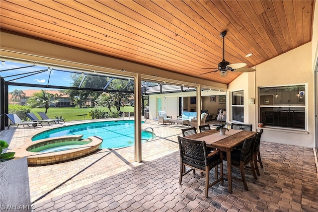 view of pool featuring a patio area, ceiling fan, an in ground hot tub, glass enclosure, and outdoor lounge area