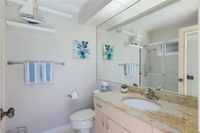 bathroom featuring tile flooring, vanity with extensive cabinet space, and toilet