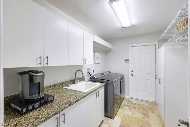 washroom featuring cabinets, light tile floors, sink, hookup for a washing machine, and washing machine and dryer