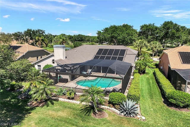 view of pool featuring a yard and glass enclosure