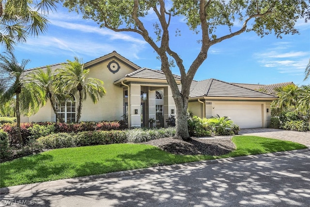 view of front of home with a front lawn and a garage