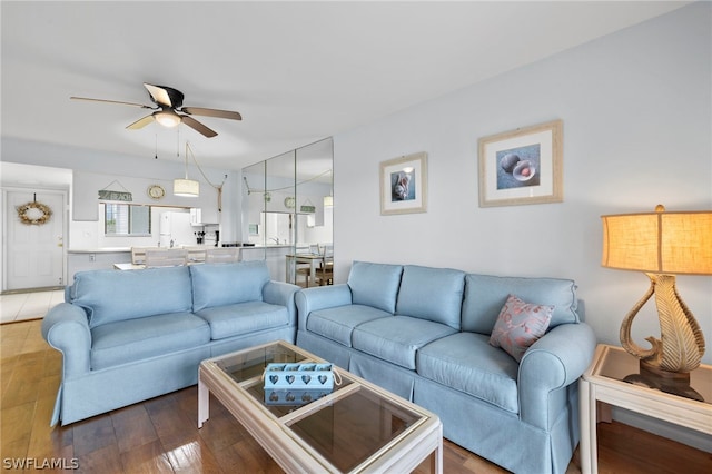 living room featuring ceiling fan and light wood-type flooring