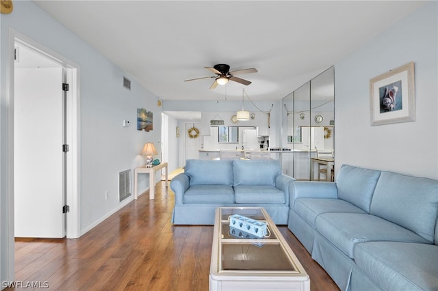 living room with ceiling fan and hardwood / wood-style floors