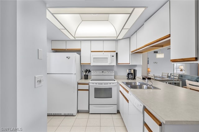 kitchen with white appliances, sink, light tile floors, and white cabinetry